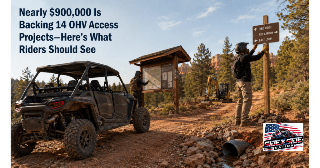 Two helmeted volunteers improve a public OHV trailhead beside an unbranded side-by-side, installing directional signs and reviewing a trail map while drainage work and maintenance equipment sit nearby.